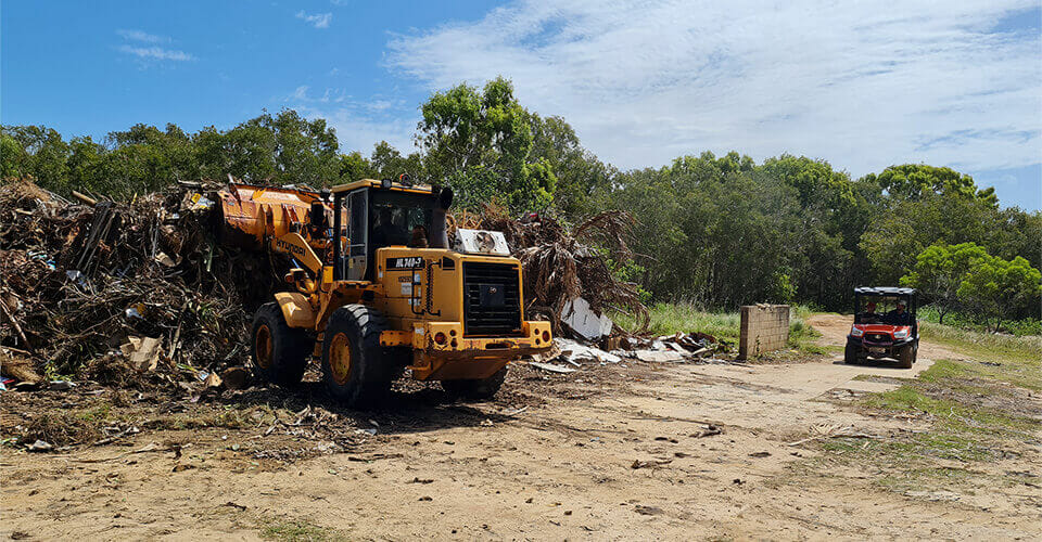 Backhoe collecting garbage