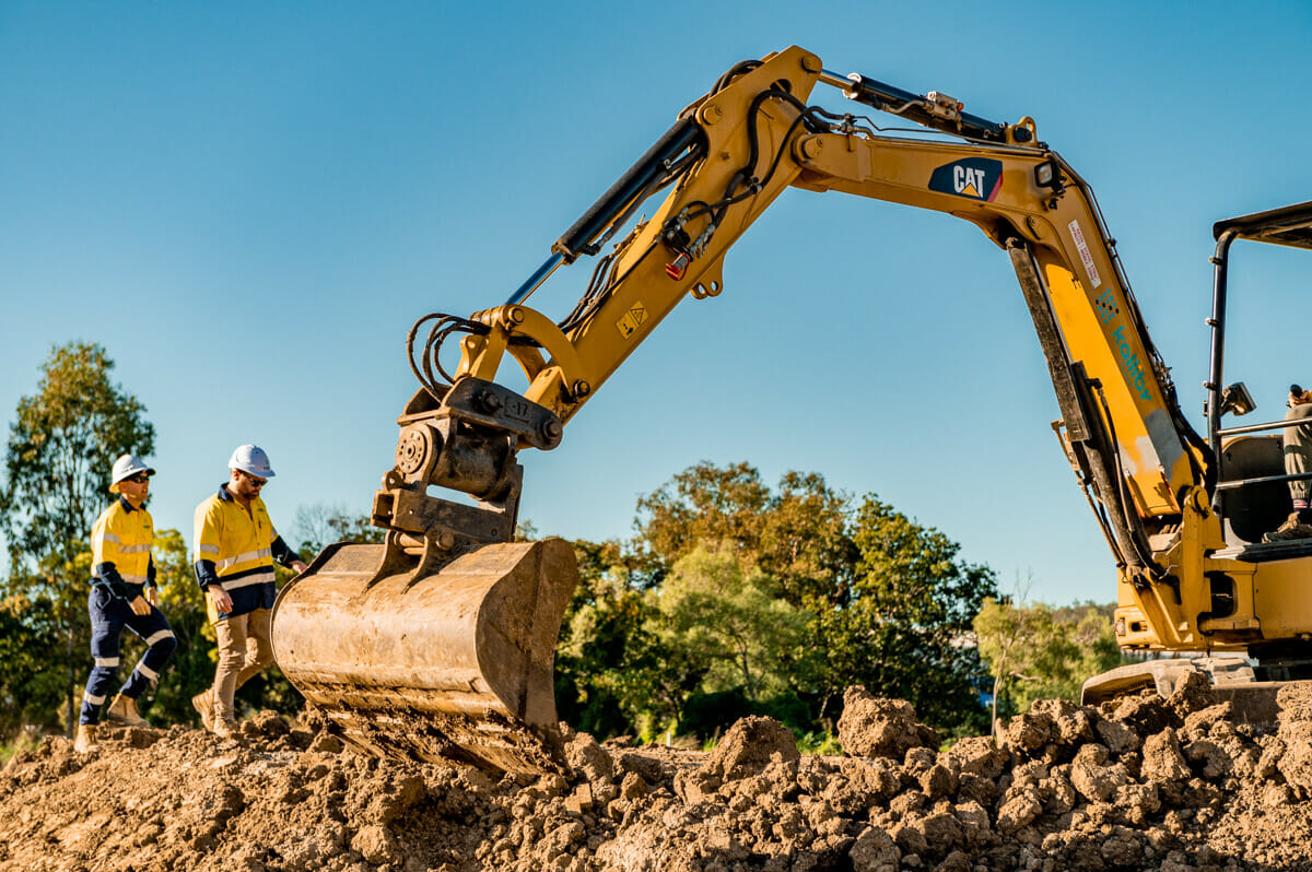 A couple of guys manning the excavator